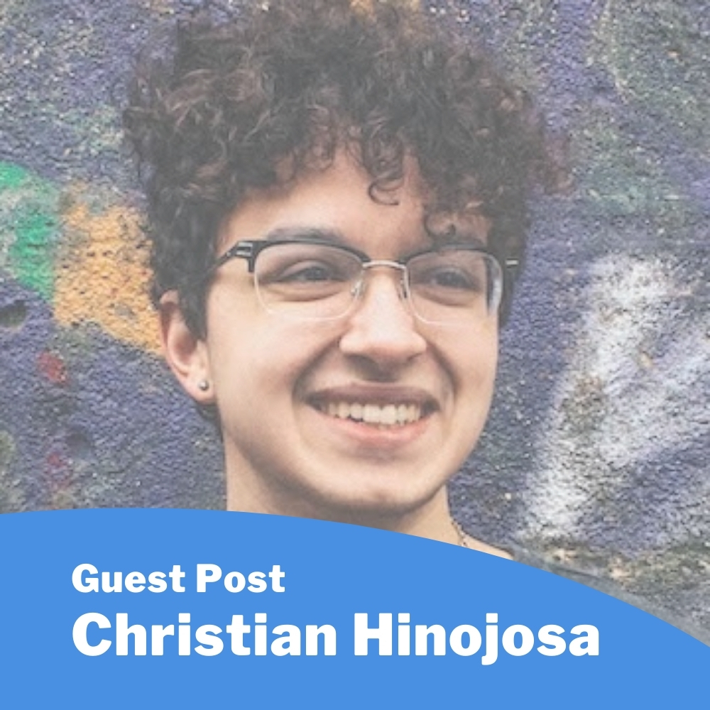 Christian Hinojosa; man with glasses and curly hair smiling